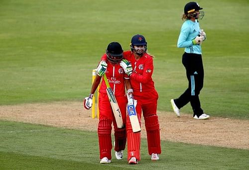 Harmanpreet and Sophie Ecclestone share a huddle after the former's heroics in yesterday's game