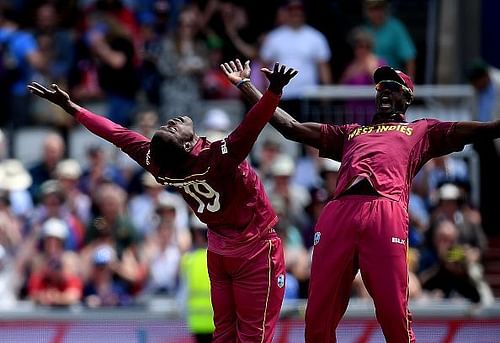 West Indies' Sheldon Cottrell celebrating with a teammate