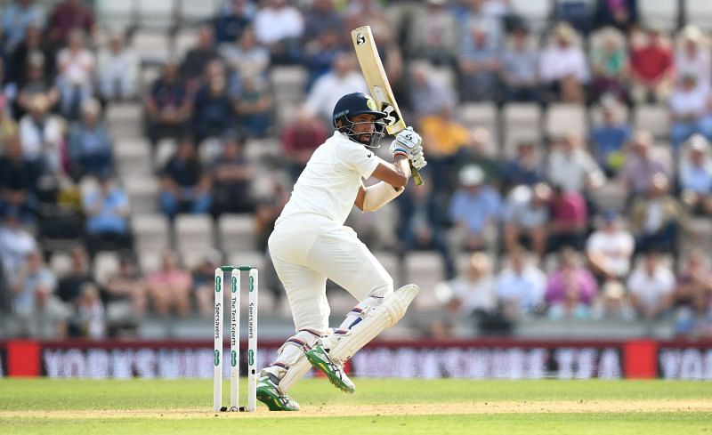 Cheteshwar Pujara carried his bat during his century against Sri Lanka in Colombo.